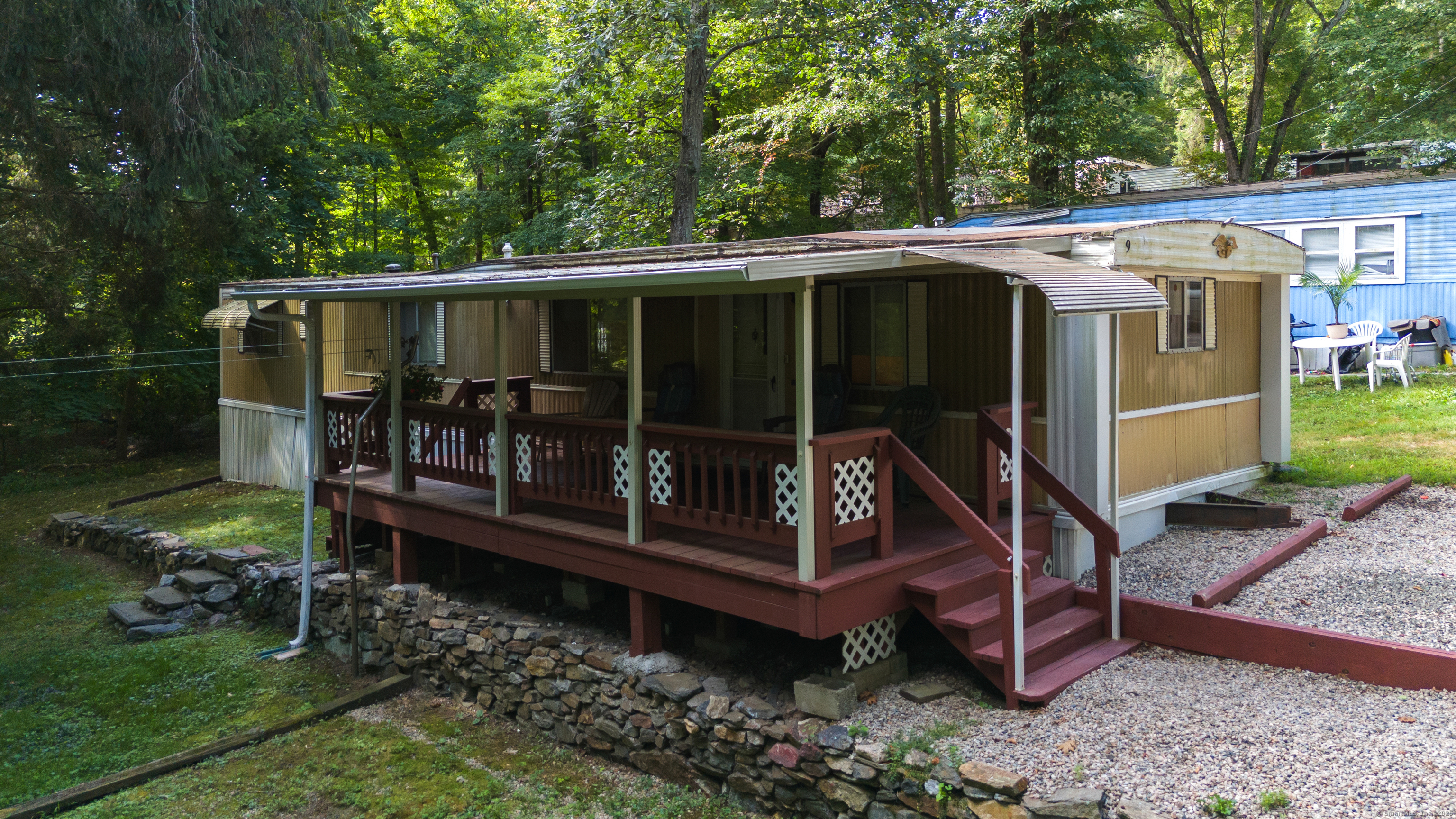 2205 Boston Post Road Guilford, CT 06437 - Photo 1 of 1 a view of a wooden deck and backyard with large trees