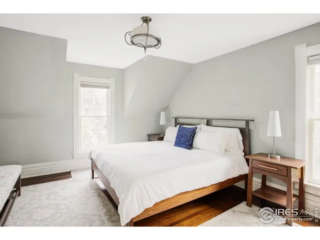 a bedroom with a bed and a chair