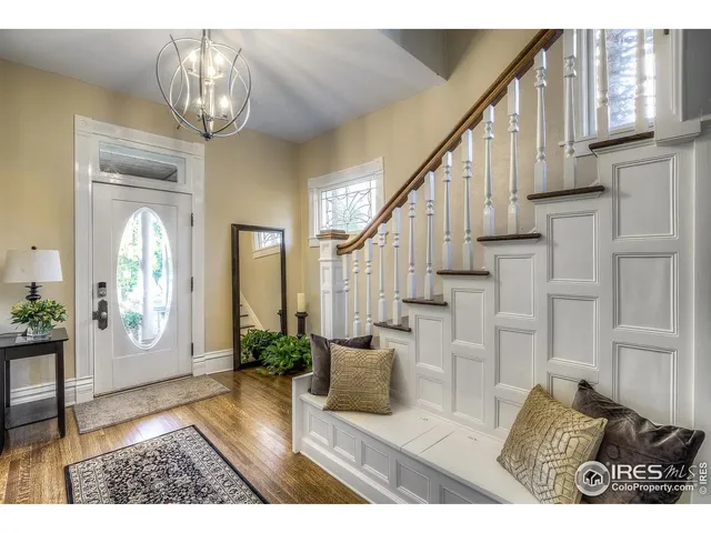 a view of entryway and hall with wooden floor