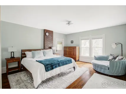 a spacious bedroom with a bed a couch and a window