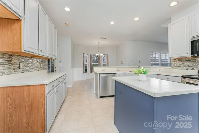 a kitchen with stainless steel appliances granite countertop a sink stove and cabinets