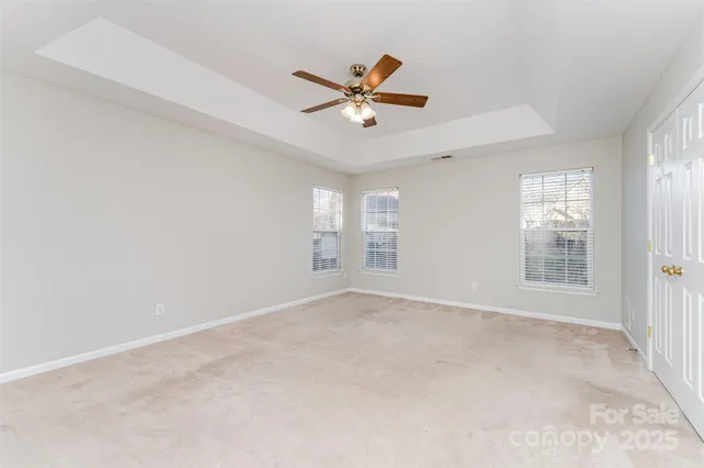 a view of a livingroom with a ceiling fan and window