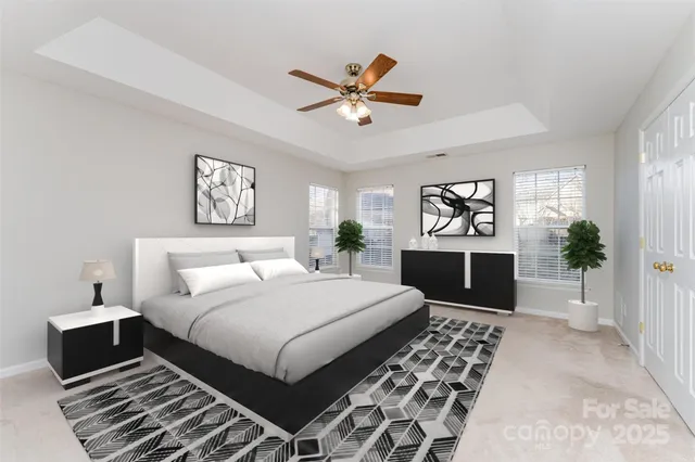 a bedroom with a large bed and a chandelier