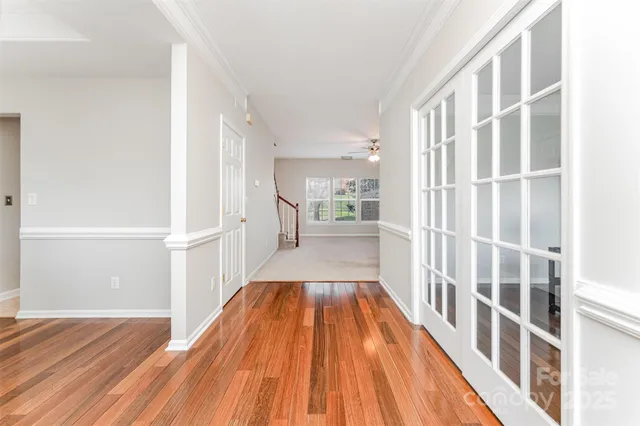 a view of a room with wooden floor and staircase