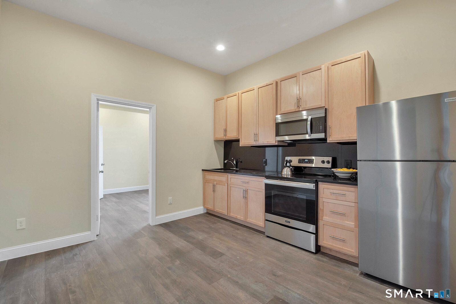 120 East Main Street, Unit 3 Torrington, CT 06790 - Photo 4 of 10 a kitchen with a refrigerator cabinets and wooden floor