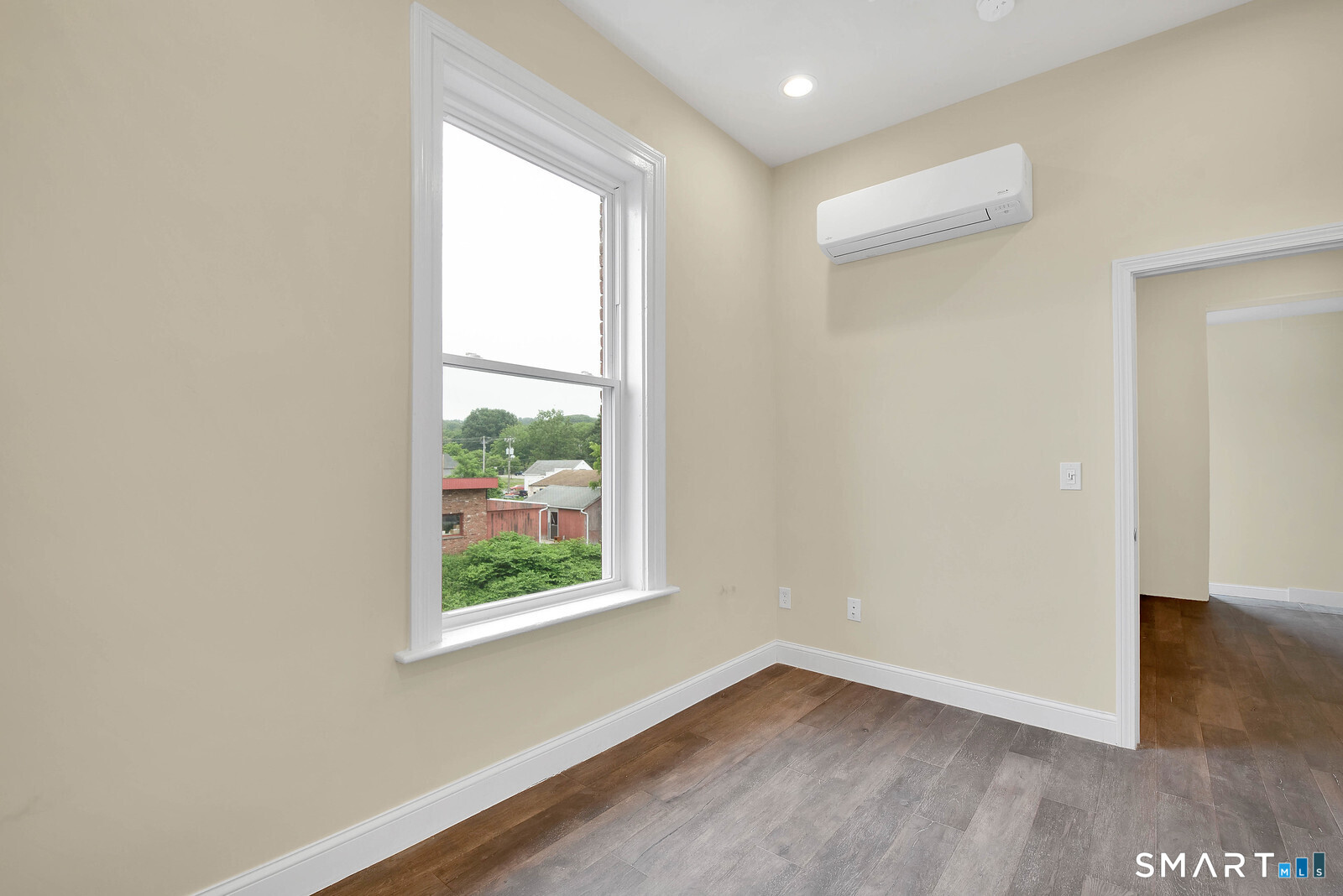 120 East Main Street, Unit 3 Torrington, CT 06790 - Photo 7 of 10 an empty room with wooden floor and windows