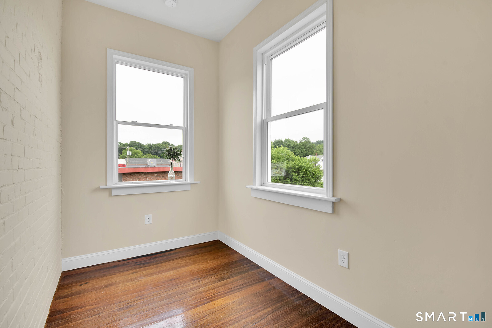 120 East Main Street, Unit 3 Torrington, CT 06790 - Photo 10 of 10 an empty room with wooden floor and windows