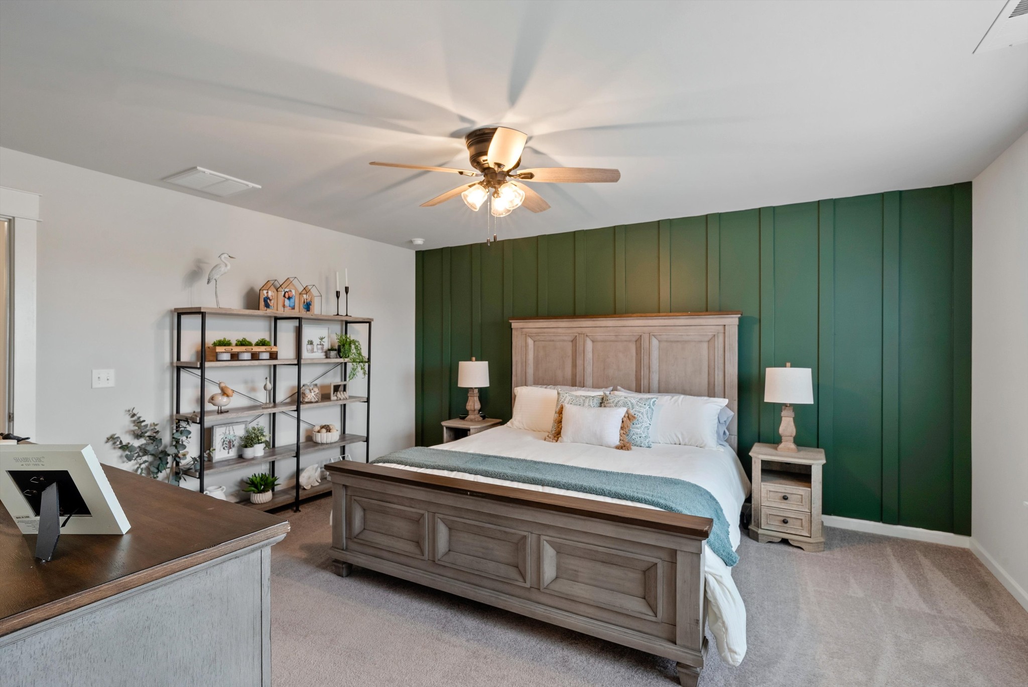 562 Torrey Pines Lane Lebanon, TN 37087 - Photo 16 of 38 a bedroom with a bed a couch and a bookshelf with wooden walls