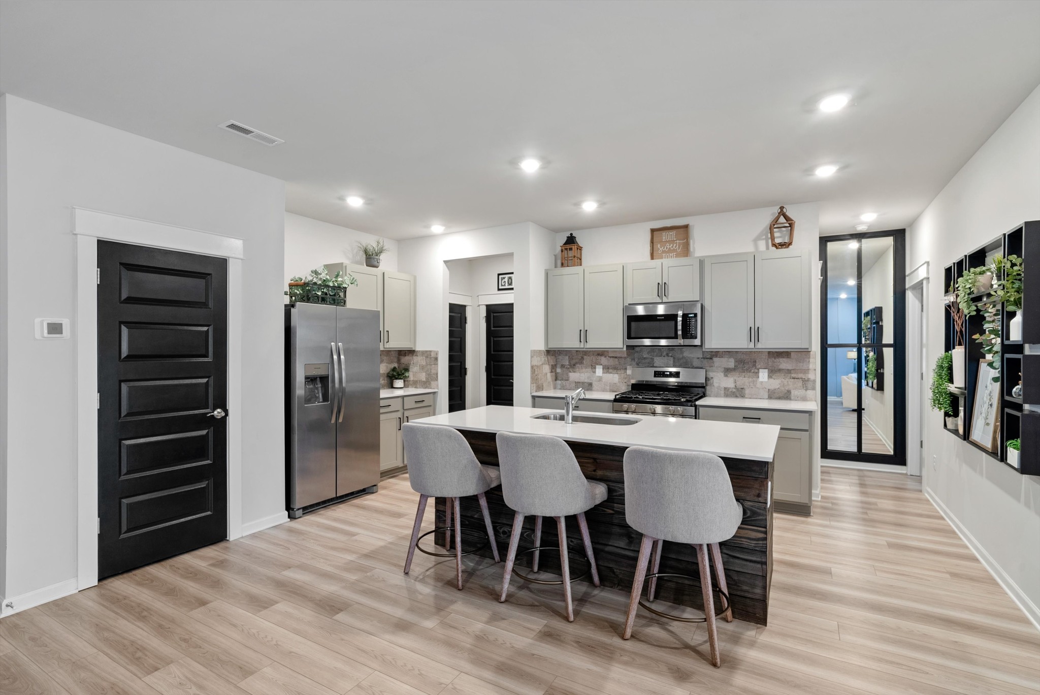 562 Torrey Pines Lane Lebanon, TN 37087 - Photo 9 of 38 a kitchen with stainless steel appliances kitchen island granite countertop a refrigerator and a stove top oven