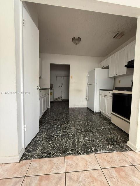 655 Southwest 6th Terrace Florida City, FL 33034 - Photo 11 of 15 a view of a refrigerator in kitchen and wooden floor