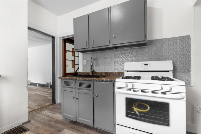 a kitchen with a stove top oven and cabinets