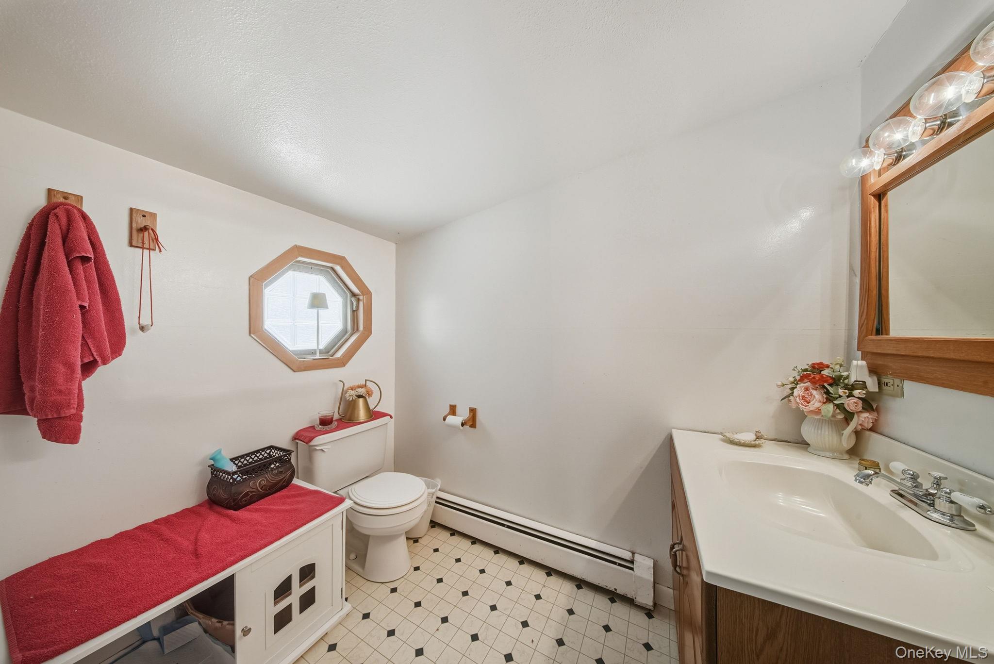 41 Birch Road Wurtsboro, NY 12790 - Photo 18 of 25 a bathroom with a sink mirror and toilet