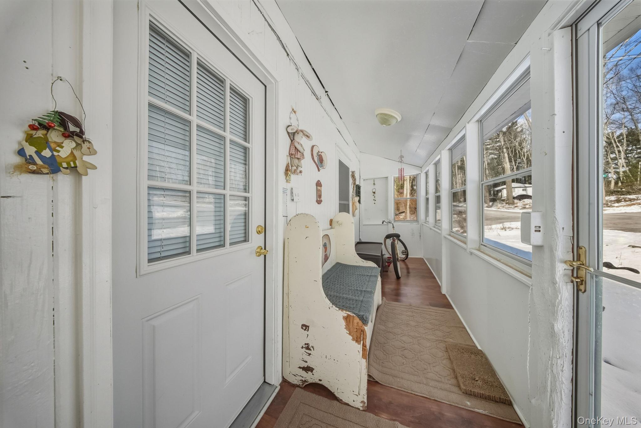 41 Birch Road Wurtsboro, NY 12790 - Photo 3 of 25 a hallway with windows and chandelier