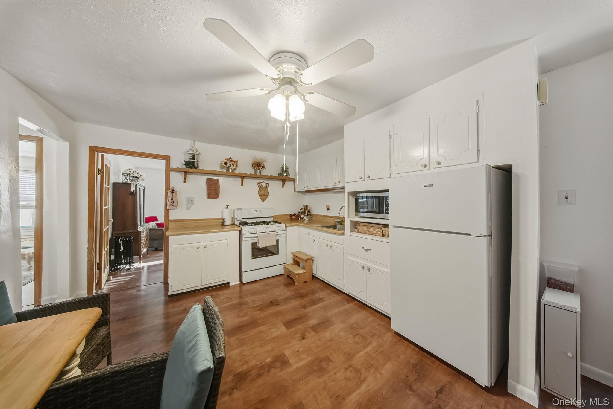41 Birch Road Wurtsboro, NY 12790 - Photo 9 of 25 a kitchen with white cabinets and white appliances