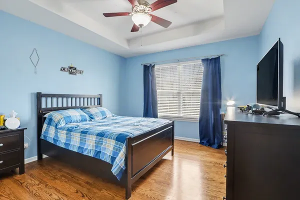 a bedroom with a bed and a chandelier