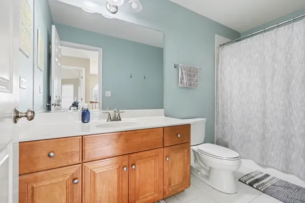 a bathroom with a sink a light fixture and a toilet