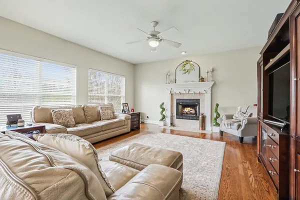 a living room with furniture a fireplace and a flat screen tv