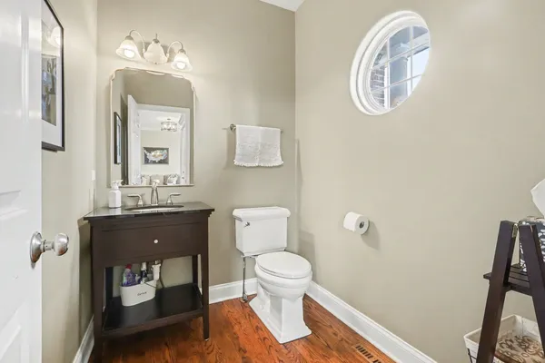 a bathroom with a toilet a sink and mirror