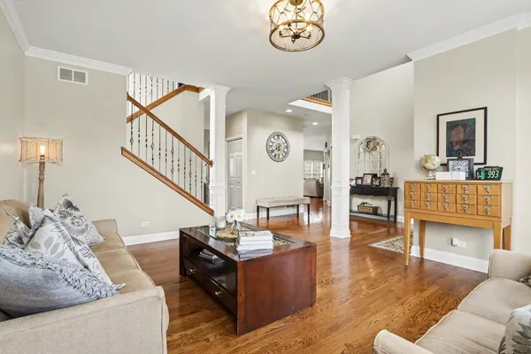 a living room with furniture and wooden floor