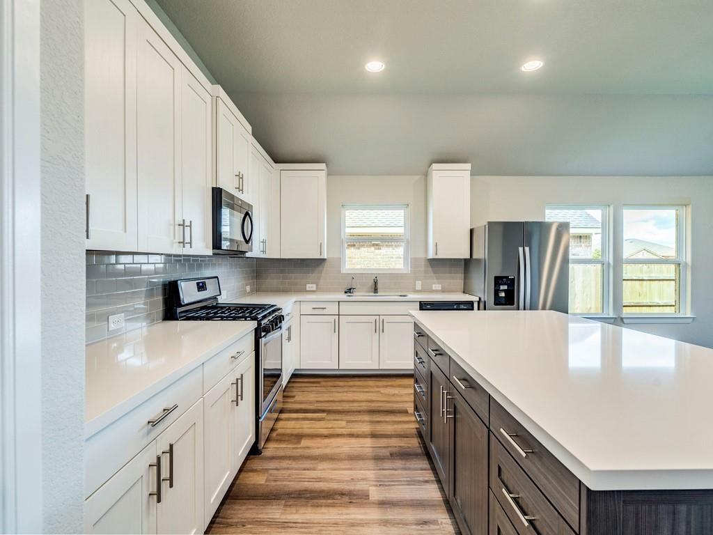 270 Rimrock Court Bastrop, TX 78602 - Photo 13 of 34 Inside, the open-concept kitchen is the heart of the home, featuring stainless steel appliances, a generous island, and plenty of space to gather, cook, and connect.