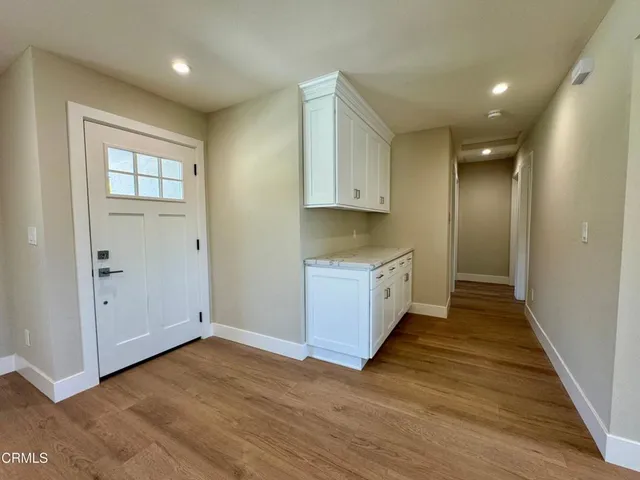 a view of a hallway with wooden floor and closet