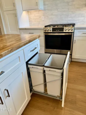 a stove top oven sitting inside of a kitchen