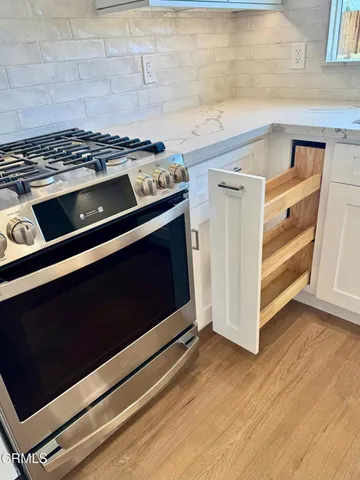 a stove top oven sitting inside of a kitchen