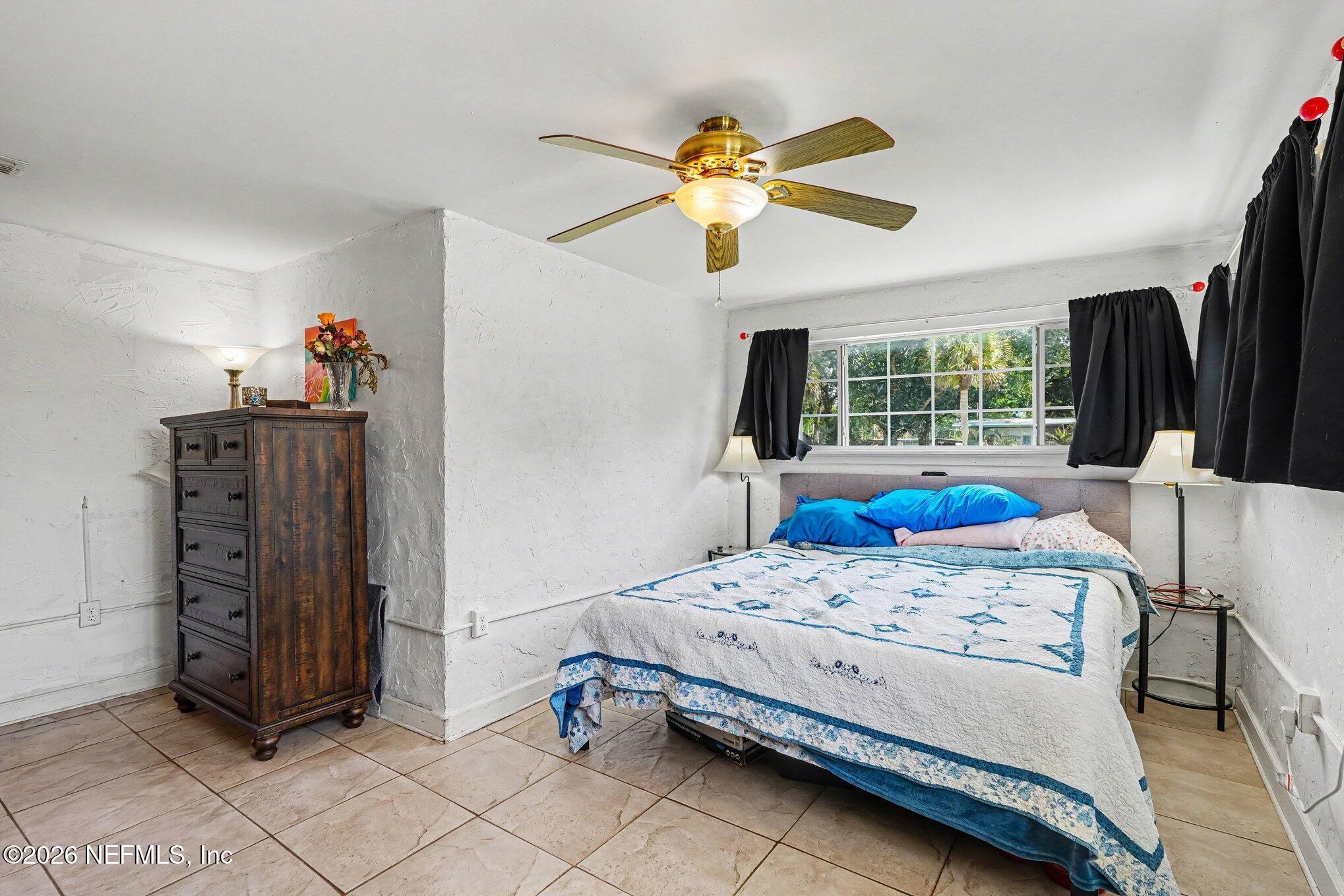 3500 Roosevelt Road Mims, FL 32754 - Photo 14 of 30 a bedroom with a bed and a chandelier