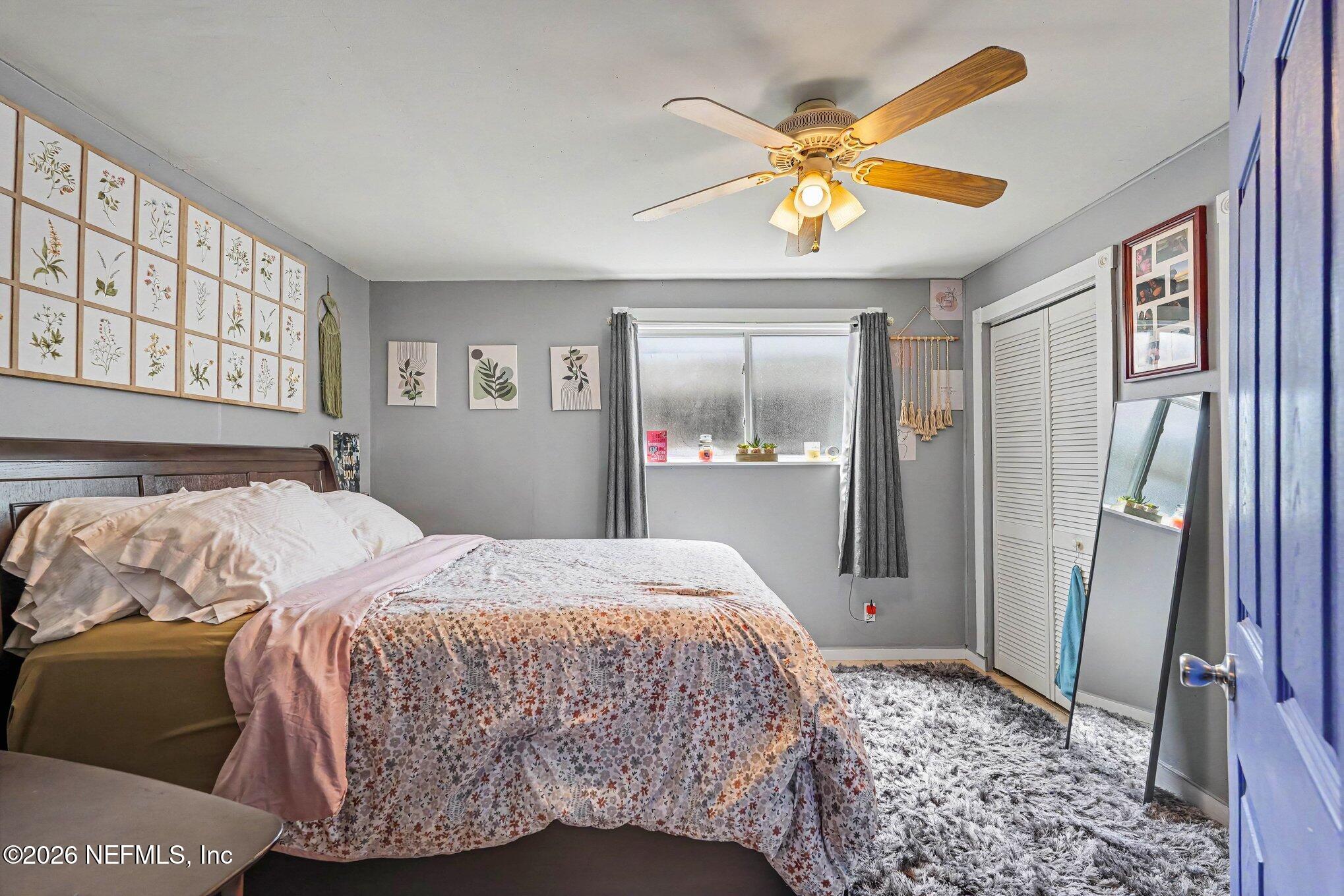 3500 Roosevelt Road Mims, FL 32754 - Photo 17 of 30 a bedroom with a bed and a window