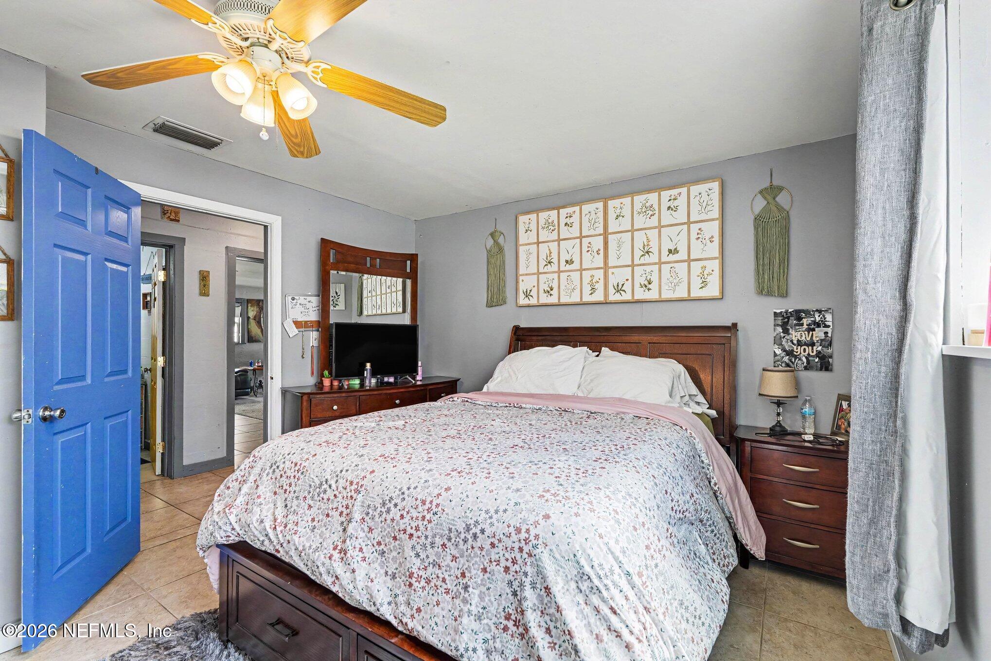 3500 Roosevelt Road Mims, FL 32754 - Photo 18 of 30 a bedroom with a bed and a chandelier