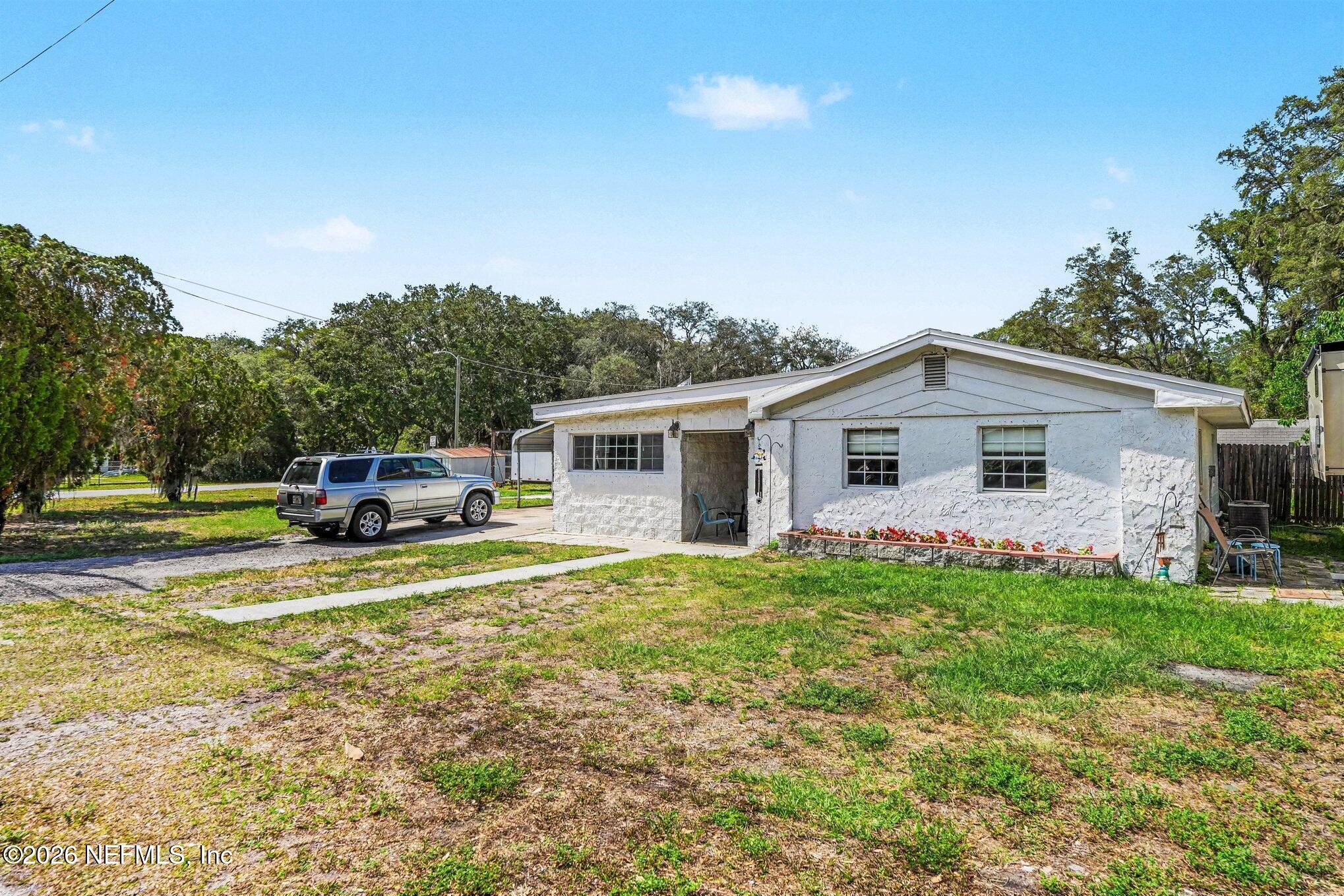 3500 Roosevelt Road Mims, FL 32754 - Photo 2 of 30 a view of a house with a patio