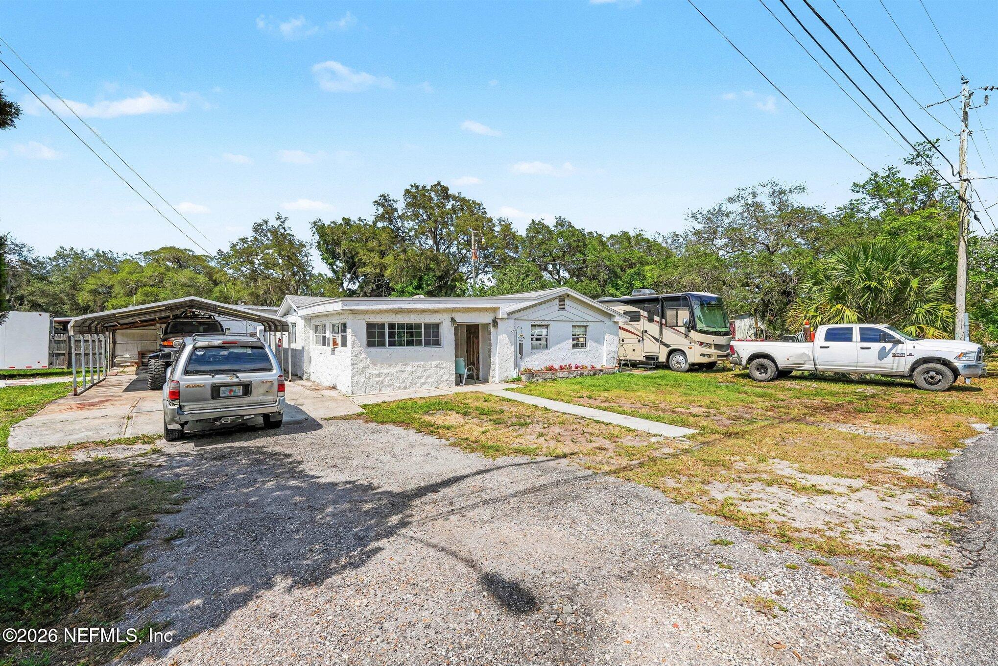 3500 Roosevelt Road Mims, FL 32754 - Photo 3 of 30 a front view of a house with a garden