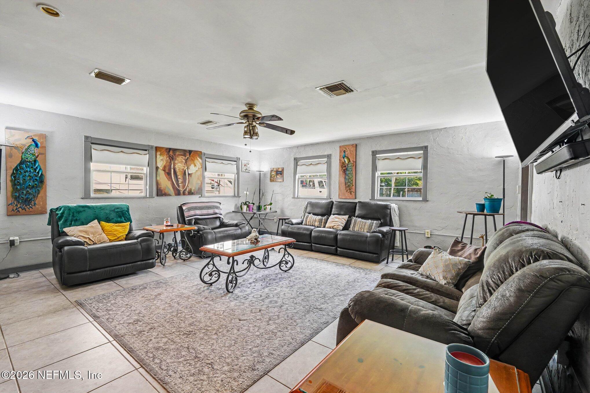 3500 Roosevelt Road Mims, FL 32754 - Photo 6 of 30 a living room with furniture and a flat screen tv