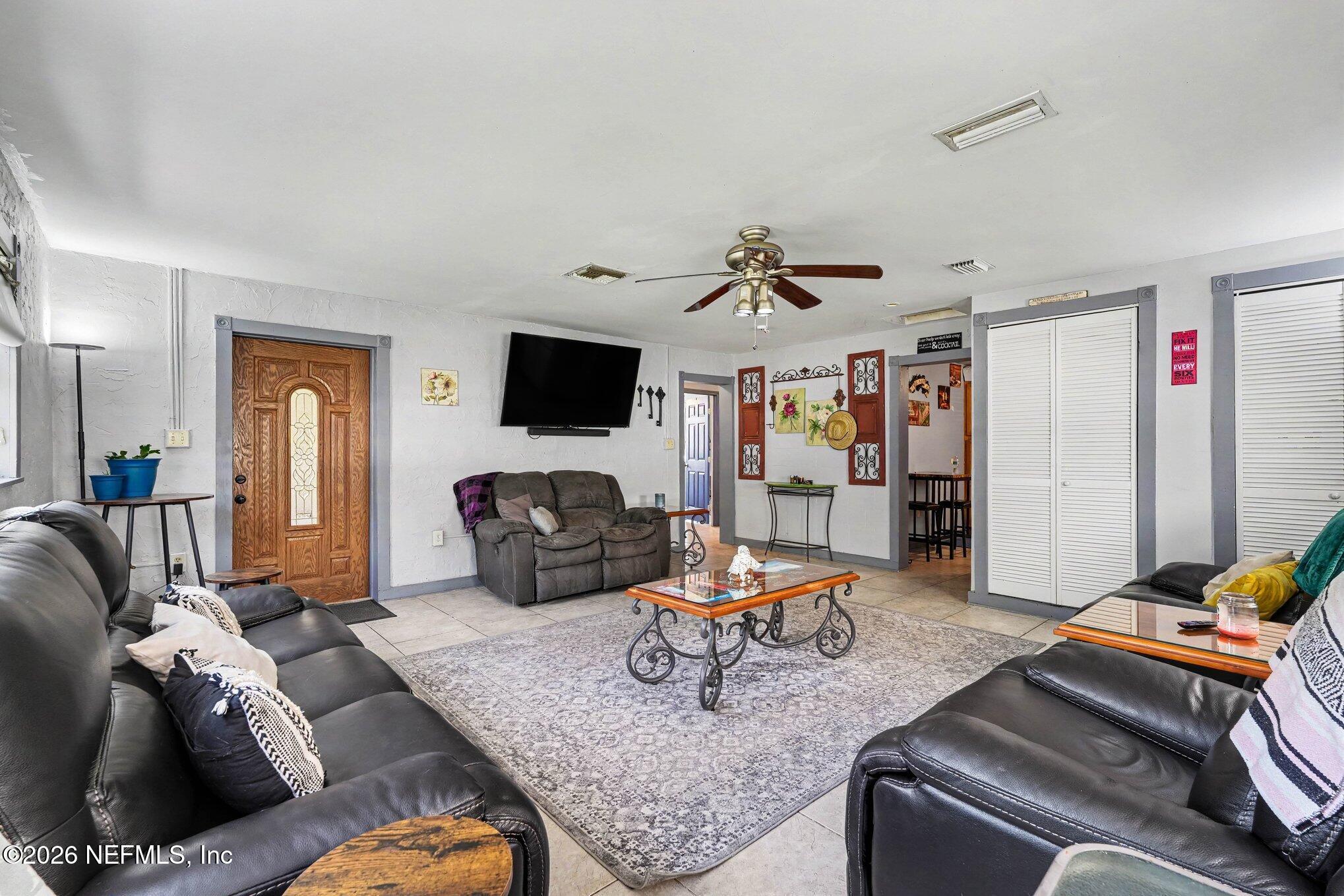 3500 Roosevelt Road Mims, FL 32754 - Photo 7 of 30 a living room with furniture and a flat screen tv