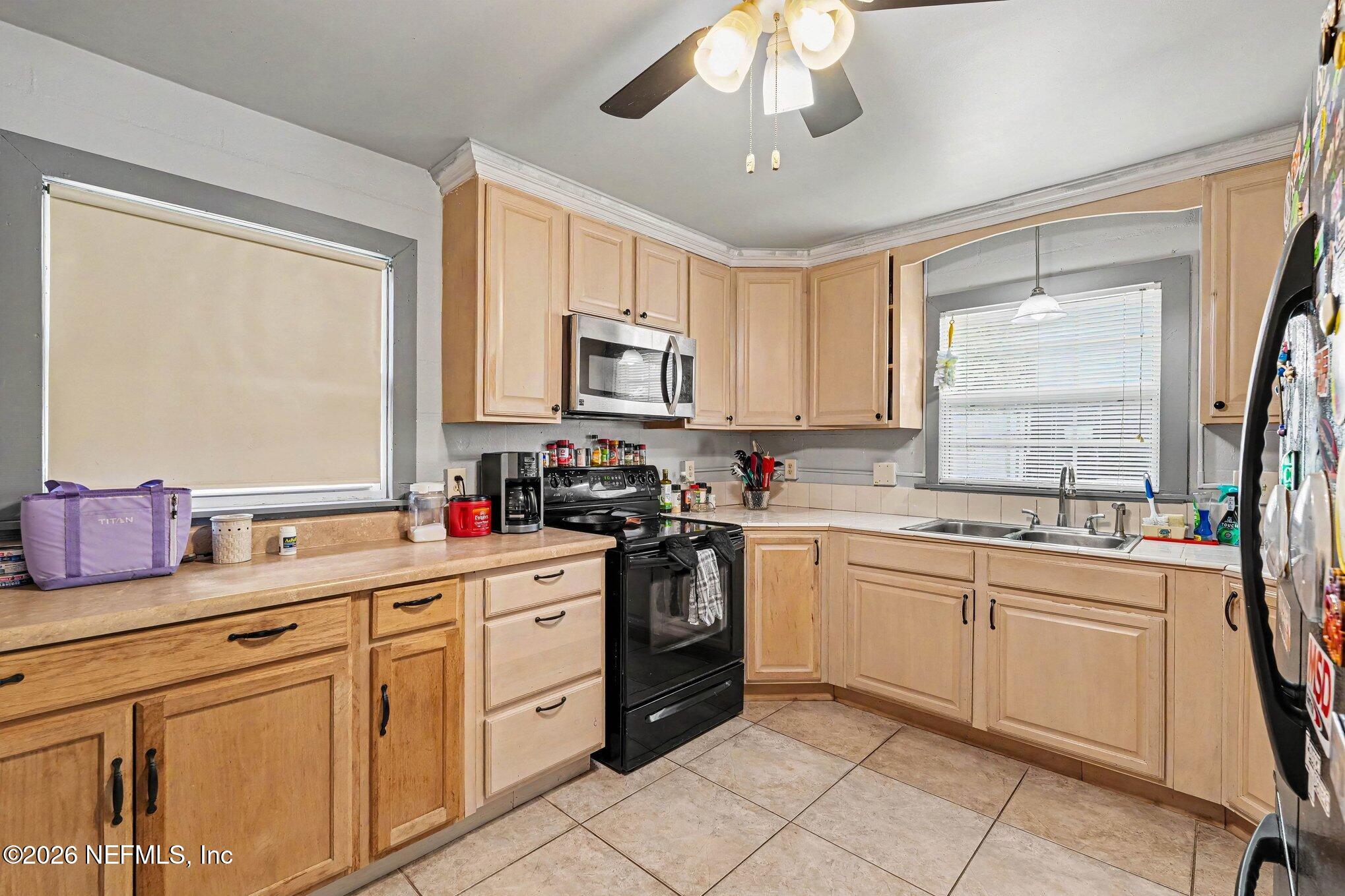 3500 Roosevelt Road Mims, FL 32754 - Photo 9 of 30 a kitchen with appliances cabinets and a sink