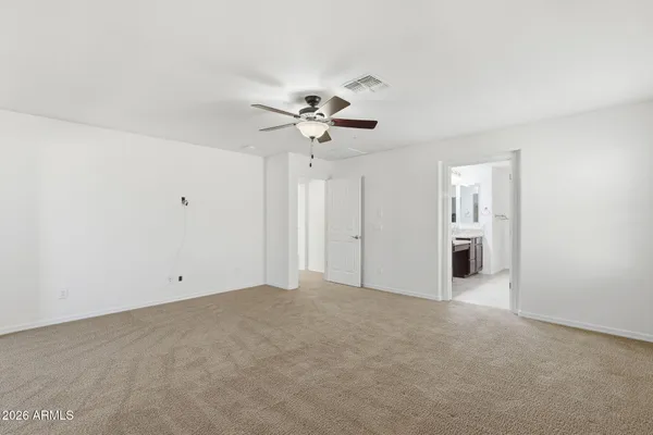 a view of an empty room with a ceiling fan