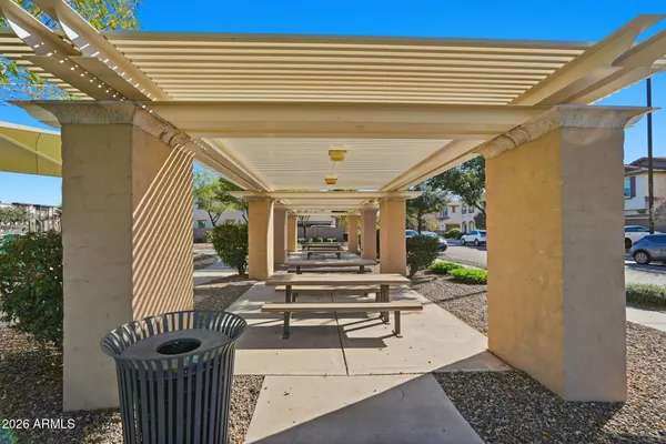 a view of a patio with couches chairs and wooden floor