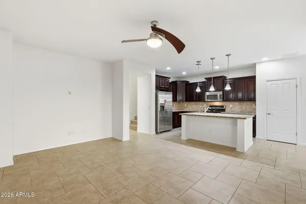 a large kitchen with kitchen island a sink stainless steel appliances and cabinets