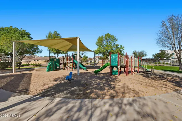 a view of a play ground in front of a house