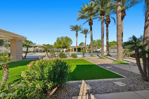 a view of a backyard with swimming pool