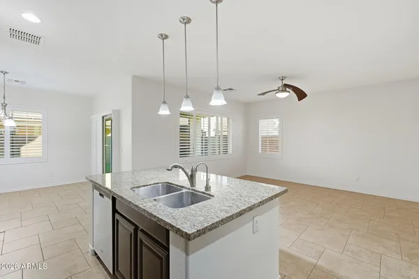 a kitchen with a sink cabinets and chandelier