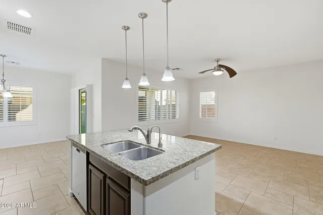 a kitchen with a sink cabinets and chandelier