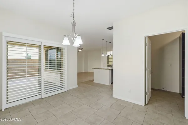 a view of a room with a door and a chandelier