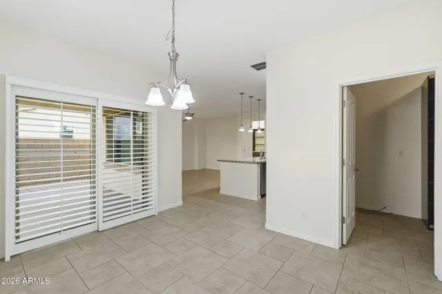 a view of a room with a door and a chandelier