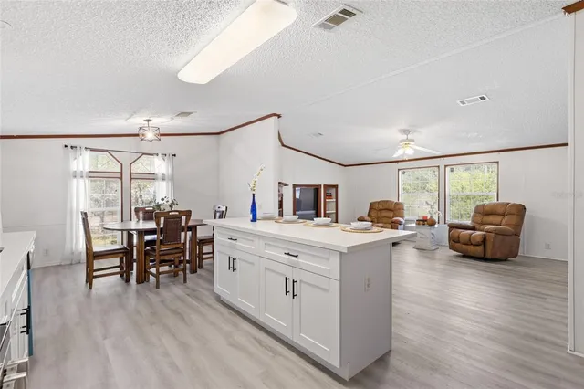 a kitchen with sink cabinets and wooden floor