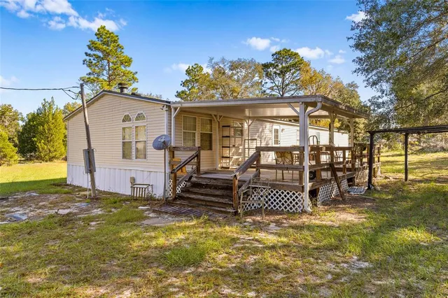 a view of a house with a swimming pool and sitting area
