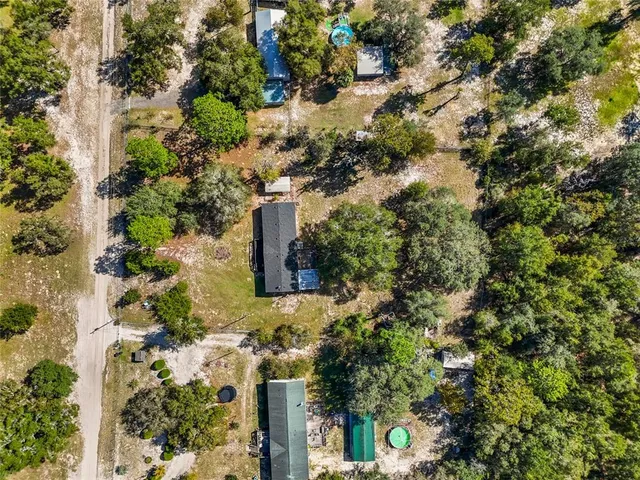 an aerial view of a house with a yard