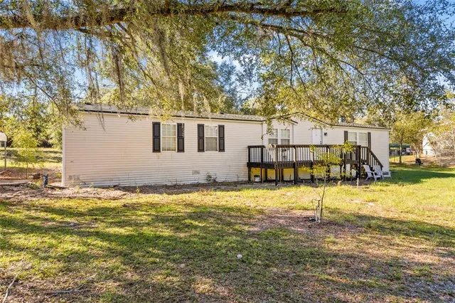 a view of a house with pool and sitting area