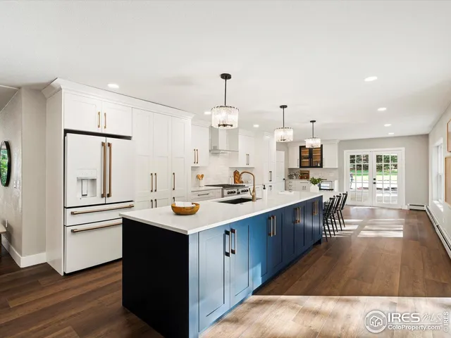 a kitchen with sink stove and refrigerator