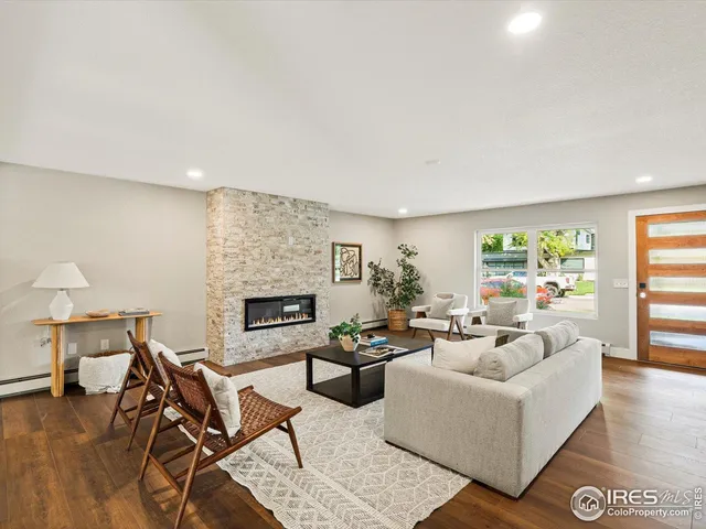 a living room with fireplace furniture and a wooden floor